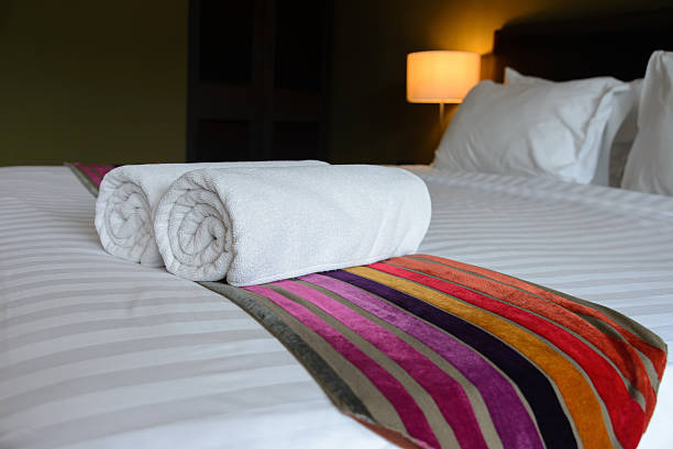istock White towel on the bed in relaxation bedroom 486262624