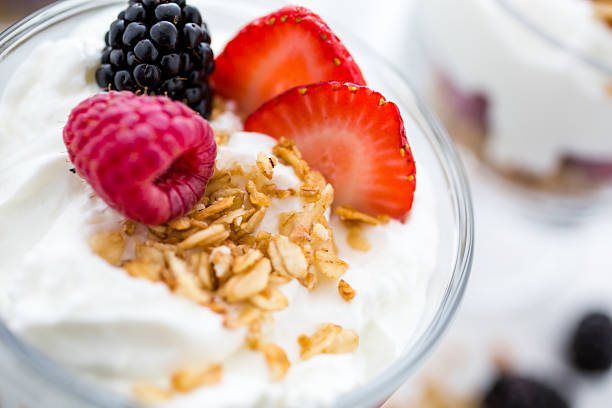 perfect Breakfast parfait made from Greek yogurt and granola topped with fresh berries. parfait stock pictures, royalty-free photos & images