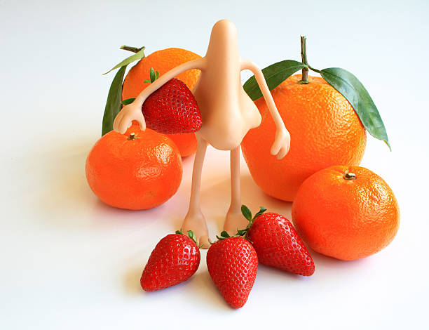istock Oranges and strawberries whith a plastic nose on white backgroun 486263910