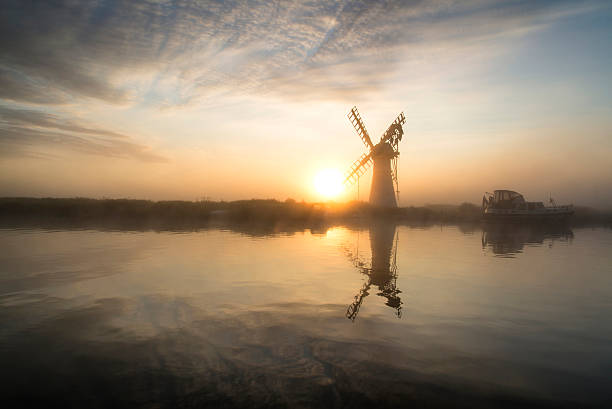 istock Stunnnig landscape of windmill and river at dawn 486264176
