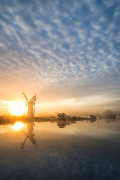 istock Stunnnig landscape of windmill and river at dawn 486264178