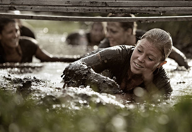 istock group of women crawling in mud 486264458