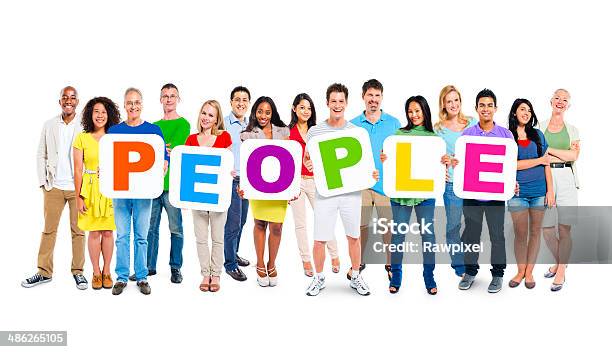 Multiethnic Group Of People Holding Alphabet To Form People Stock Photo - Download Image Now
