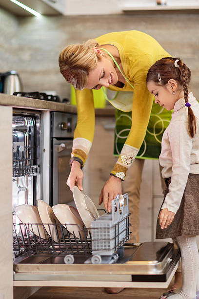 istock Mother and daughter using dishwasher in the kitchen. 486267576