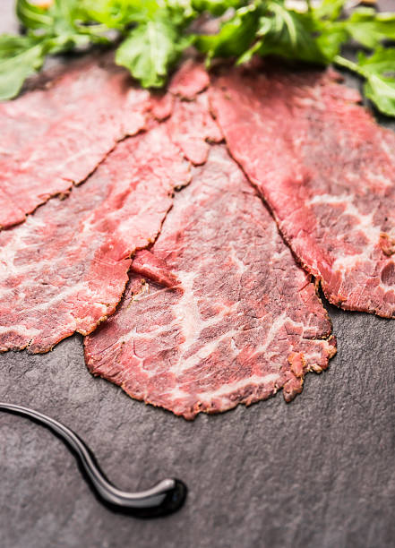 Beef Carpaccio with balsamic on slate background