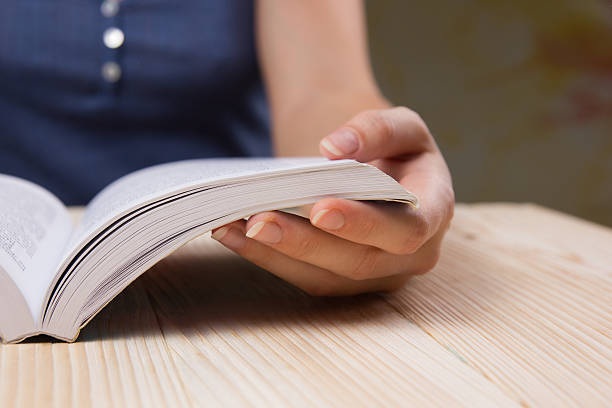istock Closeup hand open book for reading concept background 486271352
