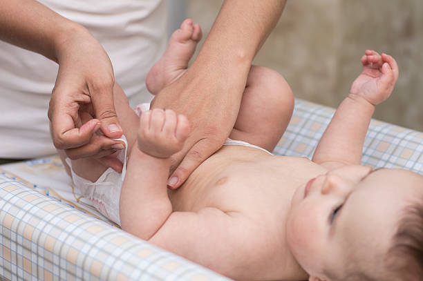 istock mom baby diaper change 486272074
