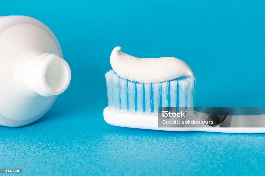 Toothbrushes and Toothpaste Toothbrush and Toothpaste on blue background. Toothpaste Stock Photo