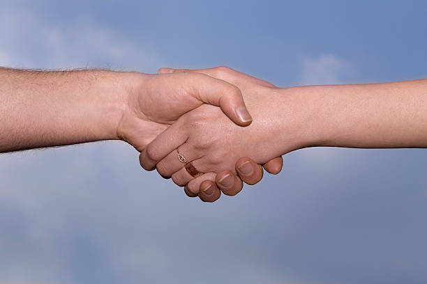 istock Man and woman handshake 1 486275278