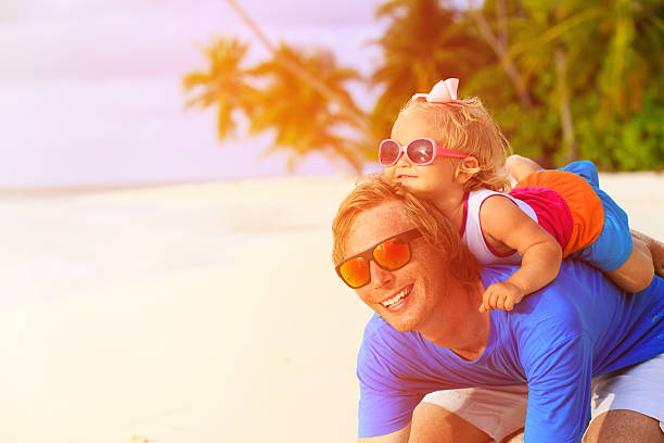 istock Happy father and little daughter at beach 486275302