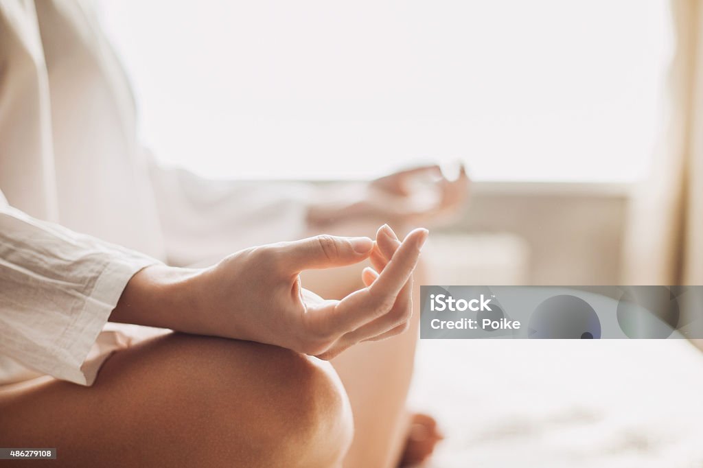 Yoga at home Hands of young beautiful woman practicing yoga indoors Meditating Stock Photo