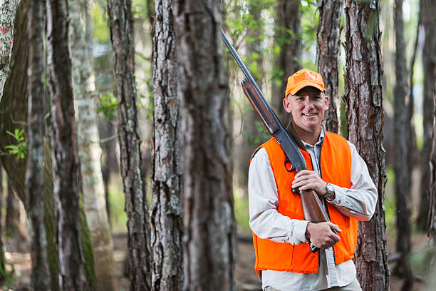 istock Man in woods hunting with shotgun 486279928