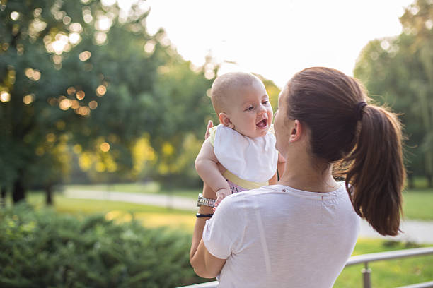 istock mother with baby in the park 486280514