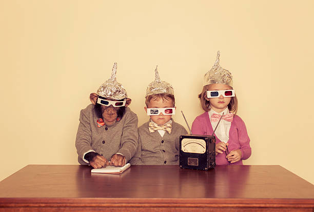 Young Children and Chimpanzee Wear Tinfoil Hats