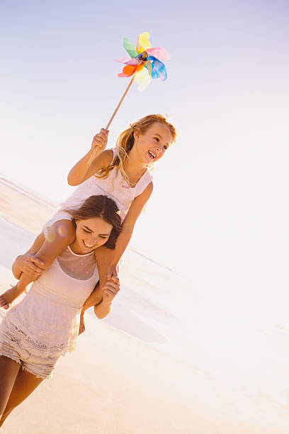 istock Mother carrying daughter on shoulders 486286635