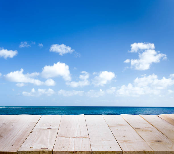 istock Wood table with blur  seascape and blue sky background 486287146