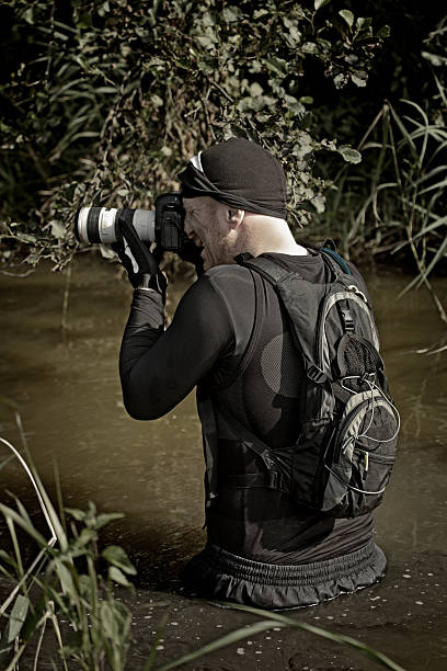 istock photographer shooting in dirty water 486287358