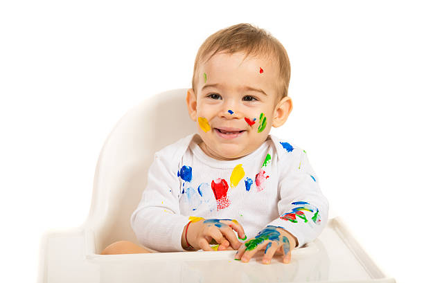 istock Laughing baby with colorful paints 486287525