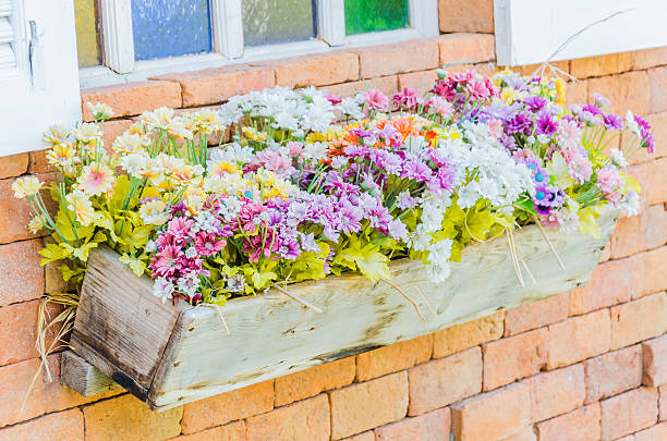 istock Plastic flower in vase on wall background 486288517