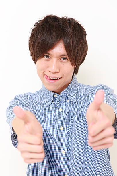 istock young man with thumbs up gesture 486288559