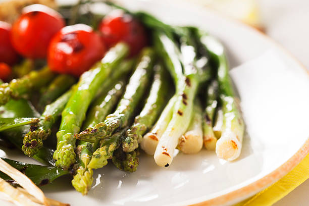 istock grilled vegetables - asparagus, onions, peas, tomatoes 486289027