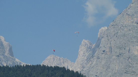 Two flying parachutist in the Italian Alps