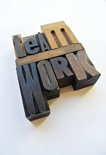 Woodtype letters forming the word teamwork