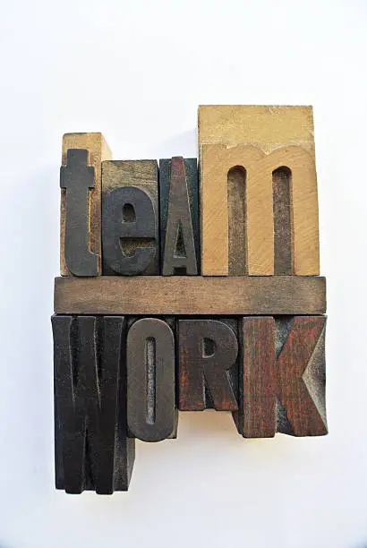 Woodtype letters forming teamwork word