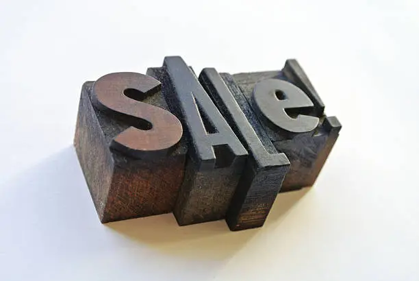 Wooden typography forming sale word