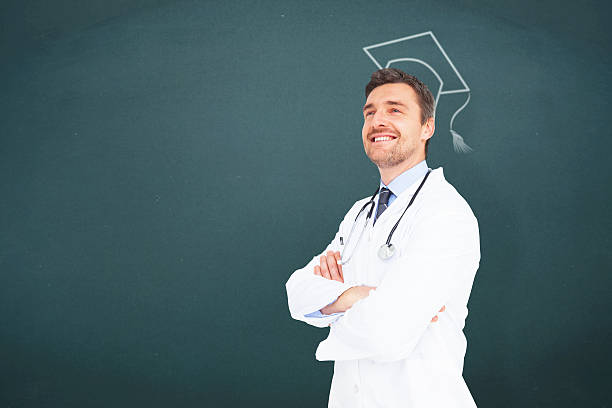 Handsome young doctor with arms crossed against teal, blue