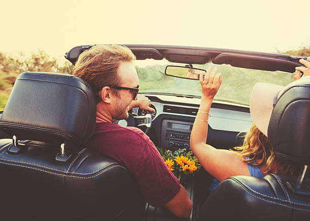 istock Happy Couple Driving in Convertible 486301872