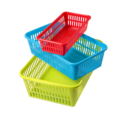 Household storage system, set colored plastic baskets of various sizes, different colors, isolated on a white background.