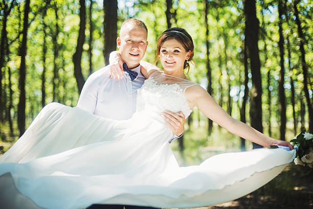 istock happy young newly married couple  in park 486304056