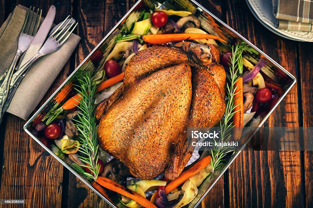 Roasted Turkey Roasted turkey in a baking pan with a variety of vegetables, ready for dinner on Thanksgiving Chicken Meat Stock Photo