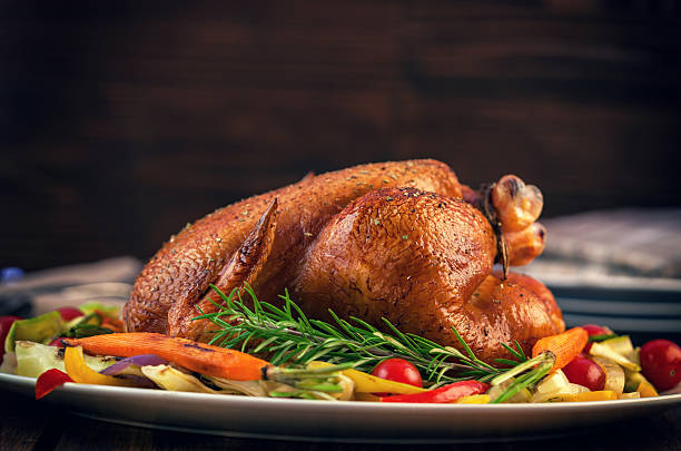 Turkey Dinner Roasted turkey served on plate with a variety of vegetables, ready for dinner on Thanksgiving turkey thanksgiving dinner cooked stock pictures, royalty-free photos & images