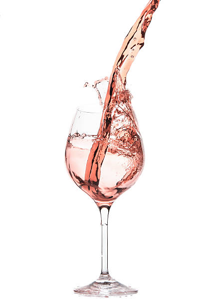 rose wine rose wine splashing on white background rosé wine stock pictures, royalty-free photos & images