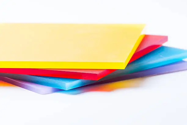 Orange yellow red blue purple plexi glass sheets on the white background