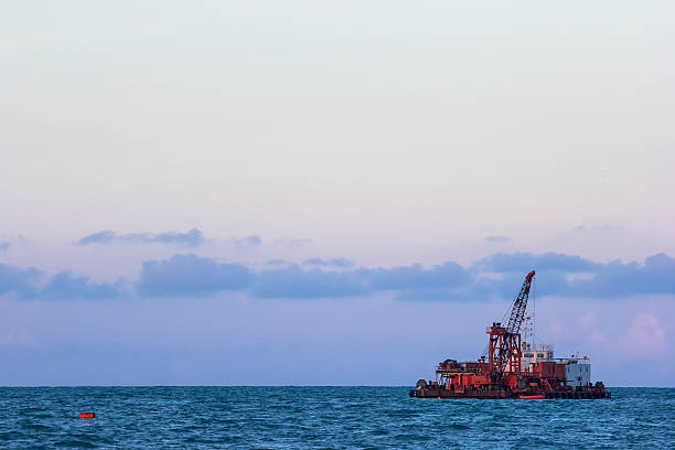 istock Dredge sand ship working at the sea in blue sky 486309527