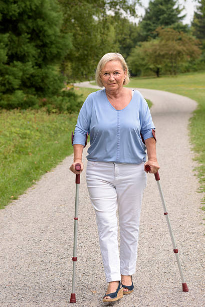 istock Middle Aged Woman Walking with Two Canes 486309614