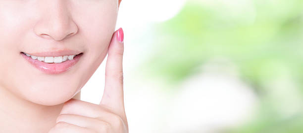 woman smile mouth with health teeth close up woman smile finger touch mouth with health teeth  on green background,skincare, dental health care  human mouth stock pictures, royalty-free photos & images