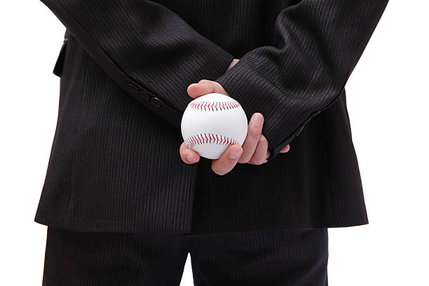 Business man holding ball in his back Boss (Business man) holding ball in his back baseball pitcher stock pictures, royalty-free photos & images