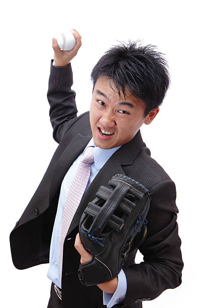 Business man pitching baseball with all his strength