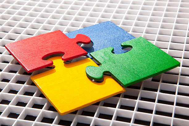 istock Four multicolored puzzle pieces coming together 486310734