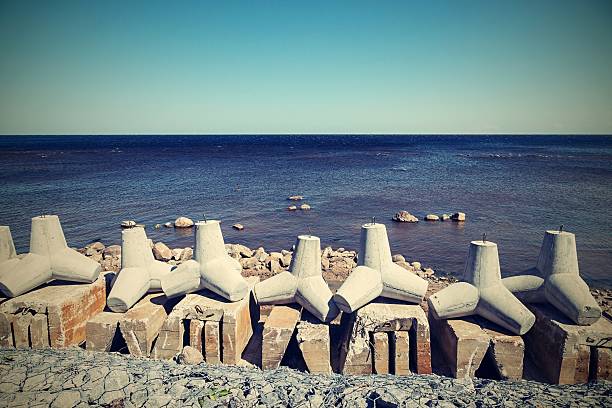 istock breakwaters on the bank sea in a retro tones 486311046