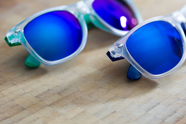 istock Two Blue mirror sunglasses on a wooden background 486311104