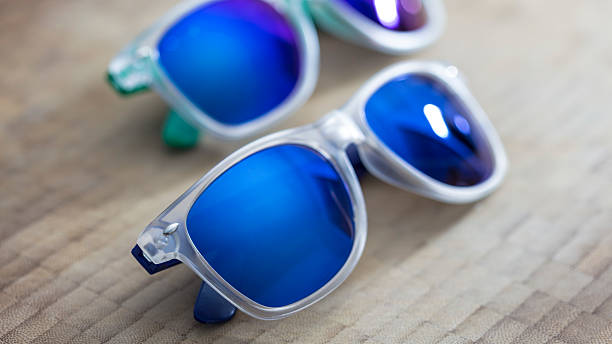 istock Two Blue mirror sunglasses on a wooden background 486311108