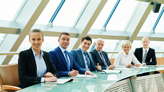 Successful business people in row looking at camera
