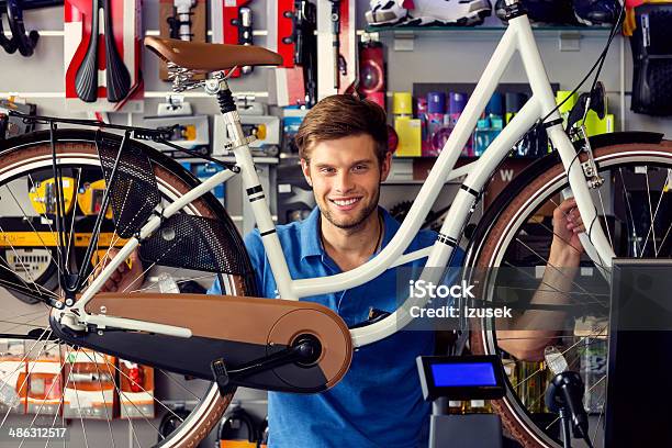 Sales Clerk With A Bicycle Stock Photo - Download Image Now - 20-24 Years, Adult, Adults Only