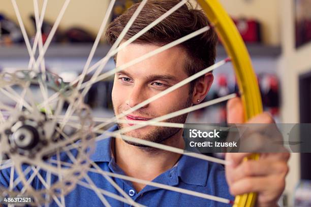 Young Man With A Bicycle Wheel Stock Photo - Download Image Now - 20-24 Years, Admiration, Adult