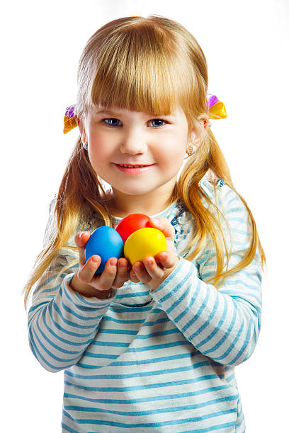 istock sweet little girl with yellow Easter egg 486314275